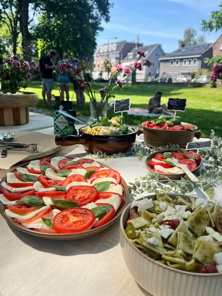 Antipastibuffet in de tuin met caprese, pastasalades en Italiaanse gerechten